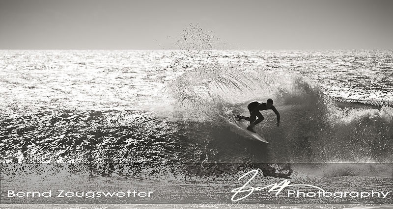 surfer turing on top of the wave
