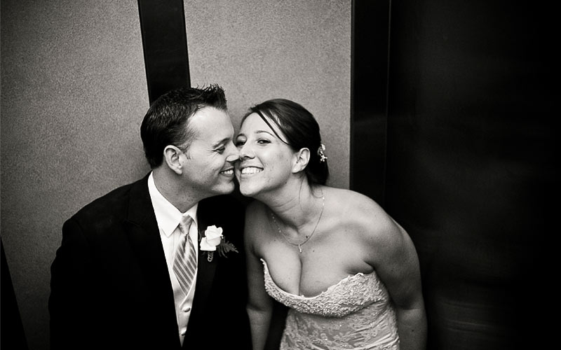 Bride and Groom laughing in the elevator 