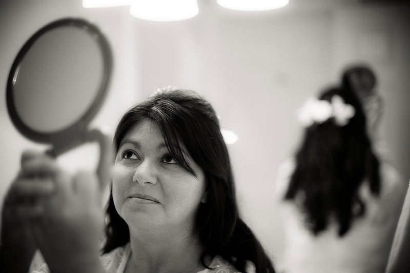 Bride checking her make-up in mirror, double reflection, San Luis Obispo