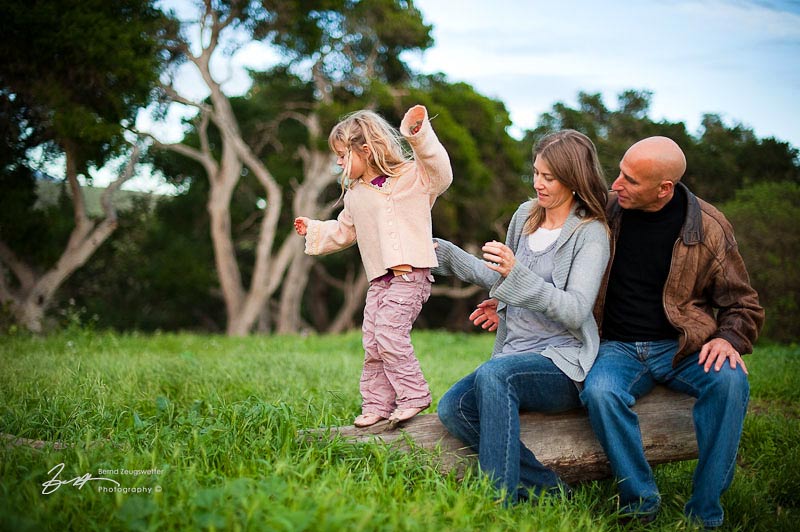 Child balancing on log, parents watching, Santa Barbara