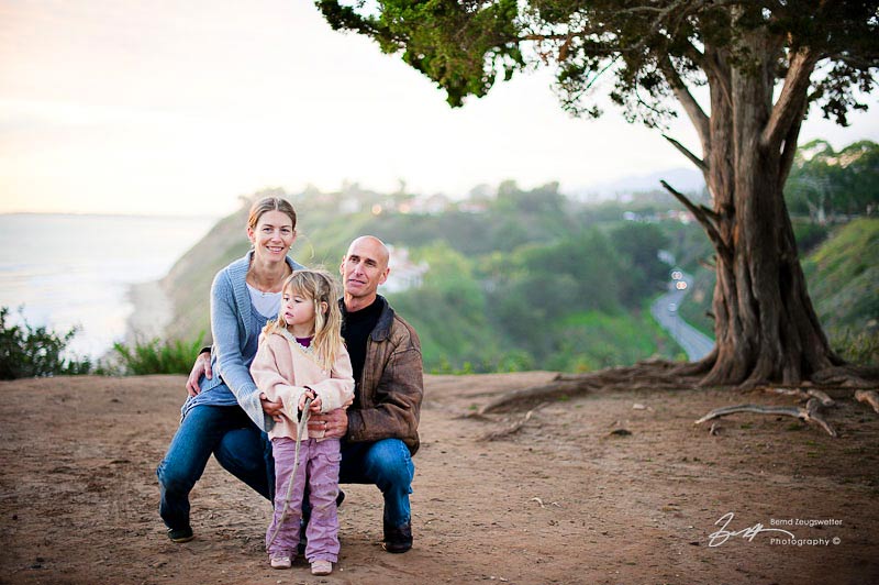 beautiful family on the edge of santa barbara bluff, sunset