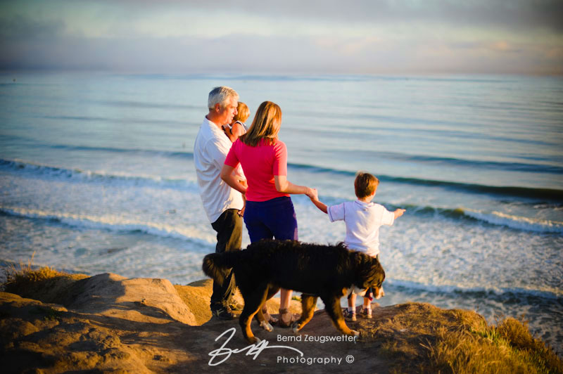 Family looking down at the waves from the bluffs, Santa Barbara.