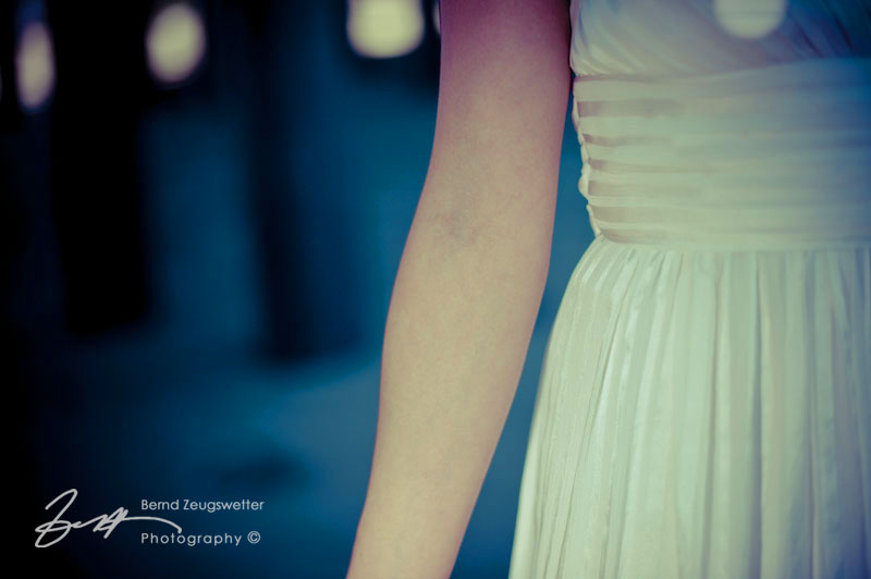 Detail of wedding gown and brides arm below the Sterns Wharf, Santa Barbara.