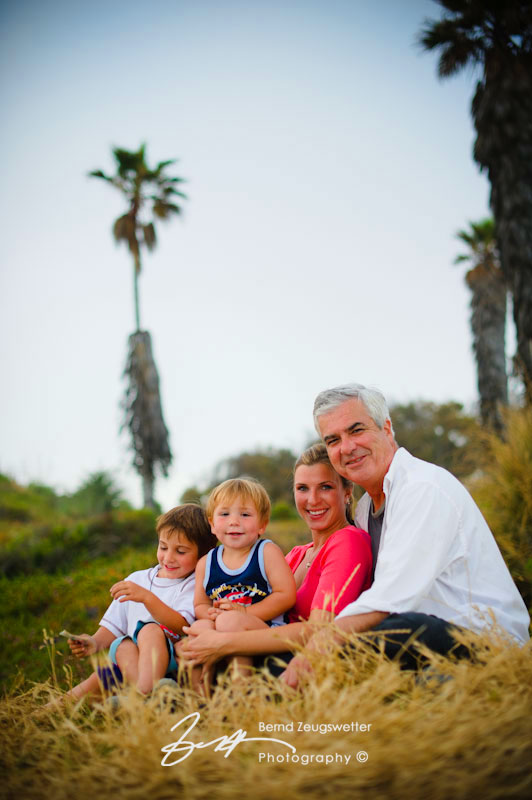 Portrait of family sitting down above the beach, Goleta, California.