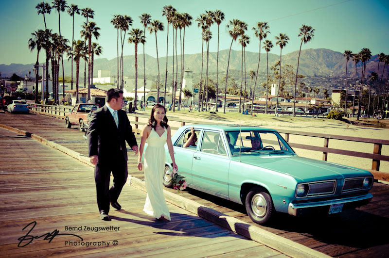 Bride and Groom walking next to a classic car on the Sterns Wharf, Santa Barbara.