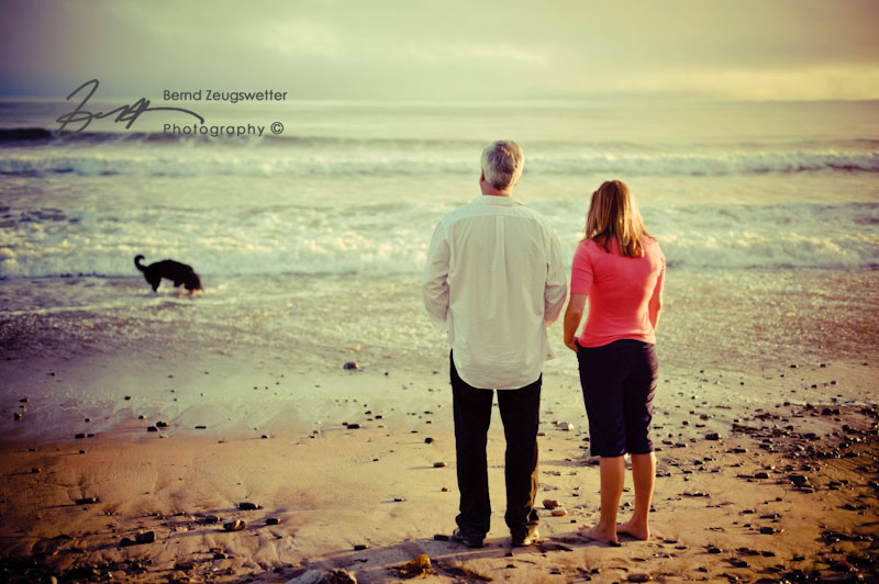 Couples Portrait at sunset with their dog in the ocean, Santa Barbara.