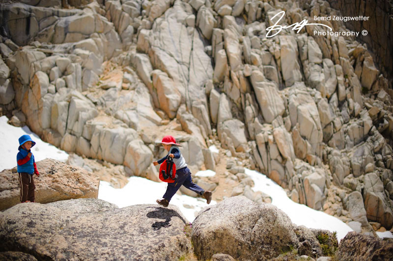 Child jumping from rock to rock near Mono Pass.