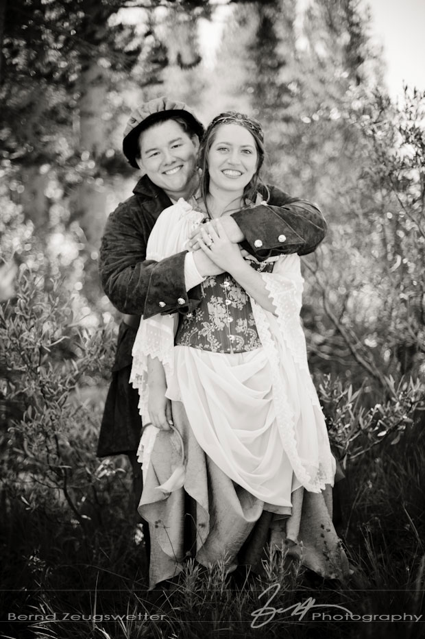 Portrait of bride and groom in renaissance dress in an aspen  grove.