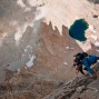 Hjordis Rickert near the top of pitch 9 with shadows of the Whitney Crest below.