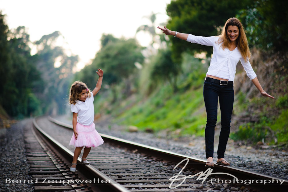 01 Santa Barbara Family Portraits Mother and daughter balancing on tracks, Santa Barbara family portrait photography.