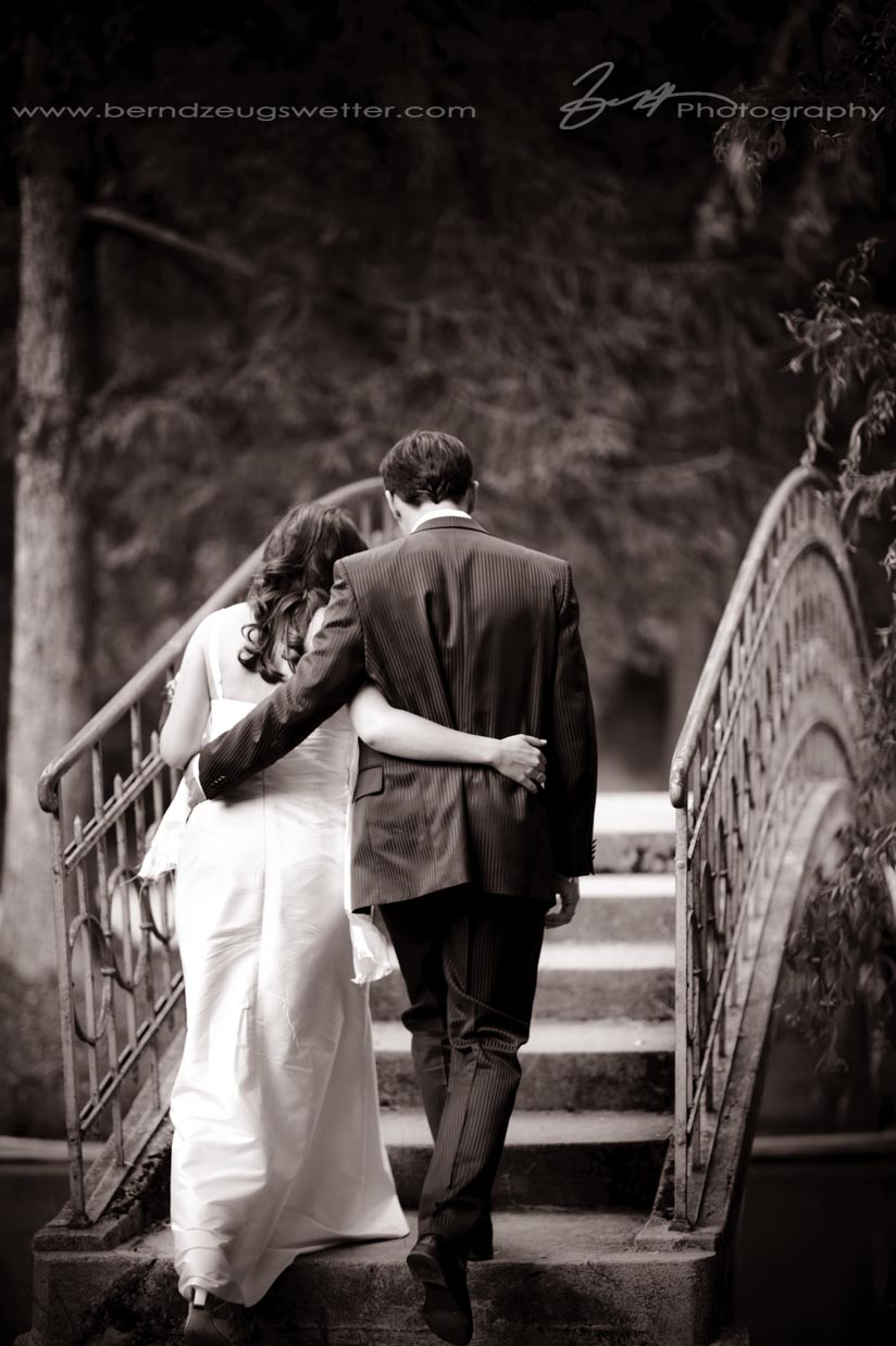 Wedding couple walking over bridge, Reichenau an der Rax, Austria.