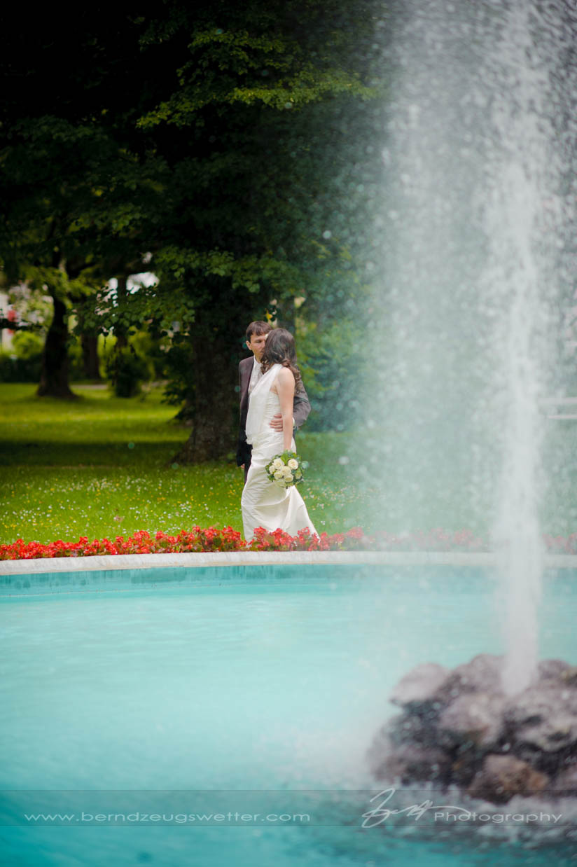 Bride and Groom at rim of fountain, Reichenau an der Rax, Austria.