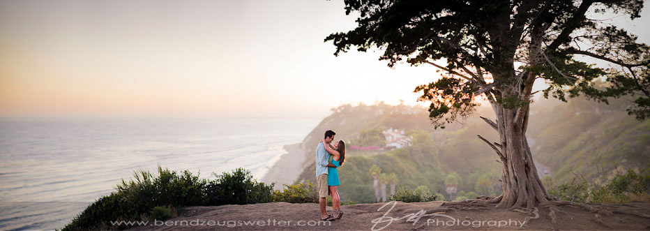 Couple standing at edge of bluff above Hendry's Beach, Santa Barbara.