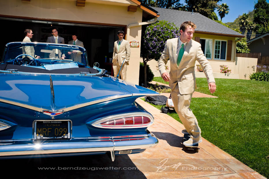 Grooms-man skating around vintage car in Santa Barbara.