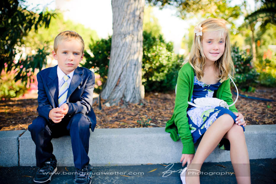 Boy and girl sitting in shade befor wedding.