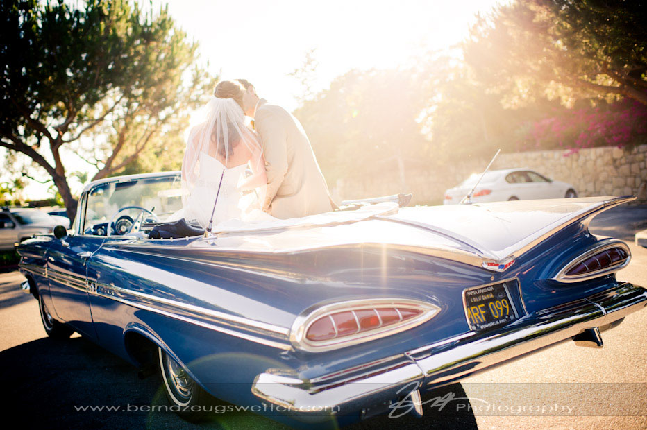 Bride and Groom kissing in vintage chevy impala, Montecito Country Club.