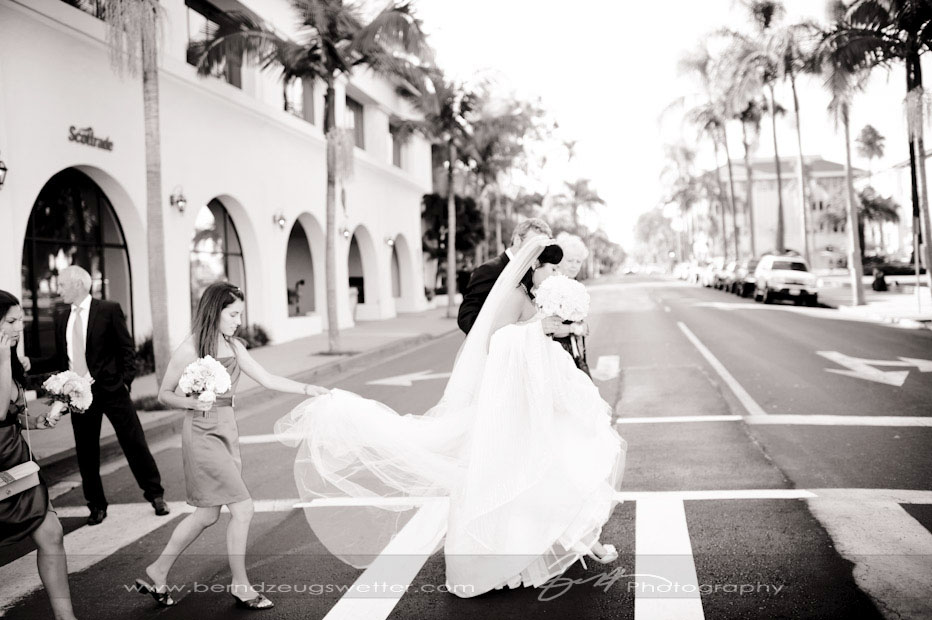Bride and groom walking from El Presidio Chapel, Santa Barbara wedding photographer.