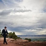 Groom walking in amazing landscape and sky, Colorado National Monument.