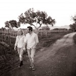 Engagement couple walking through Firestone Vineyard, Santa Ynez Valley.