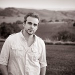 Portrait of Brandon above vineyard.