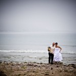 Picture of groom and bride balancing off the beach at Rincon Point