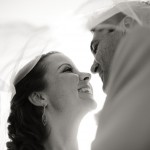 Detail of bride and groom under veil.