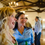 Wedding guests laughing at the reception, Santa Barbara.