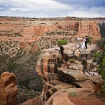 Bride and groom at cliff-side overlooking Wedding Canyon, Colorado National Monument.