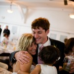 Groom receiving congratulatory hugs.