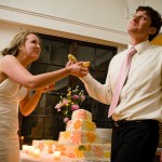 Bride and groom goofing-off with their first piece of cake.